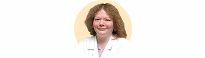 Dr Primrose Freestone against a yellow background
