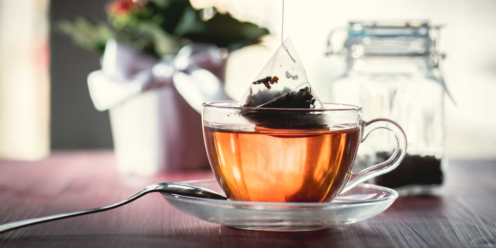 pyramid tea bag being dunked in cup