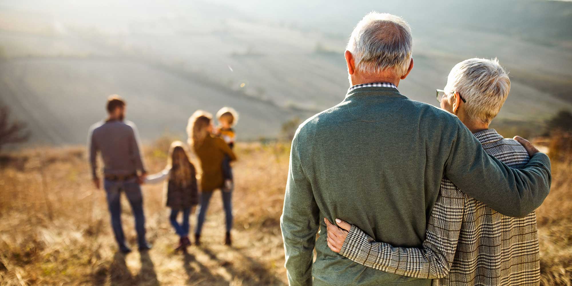 An older couple looks at their children and grandchildren