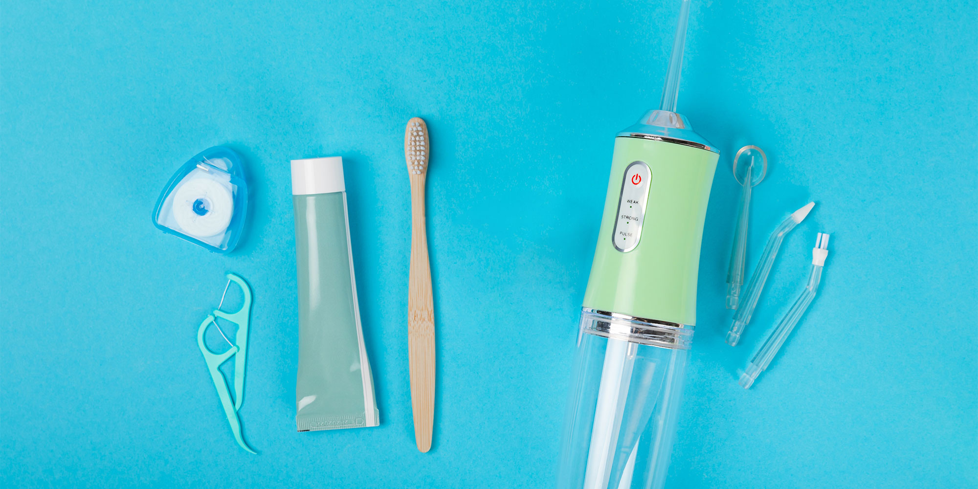 A collection of dental products like floss, a toothbrush, and a water flosser