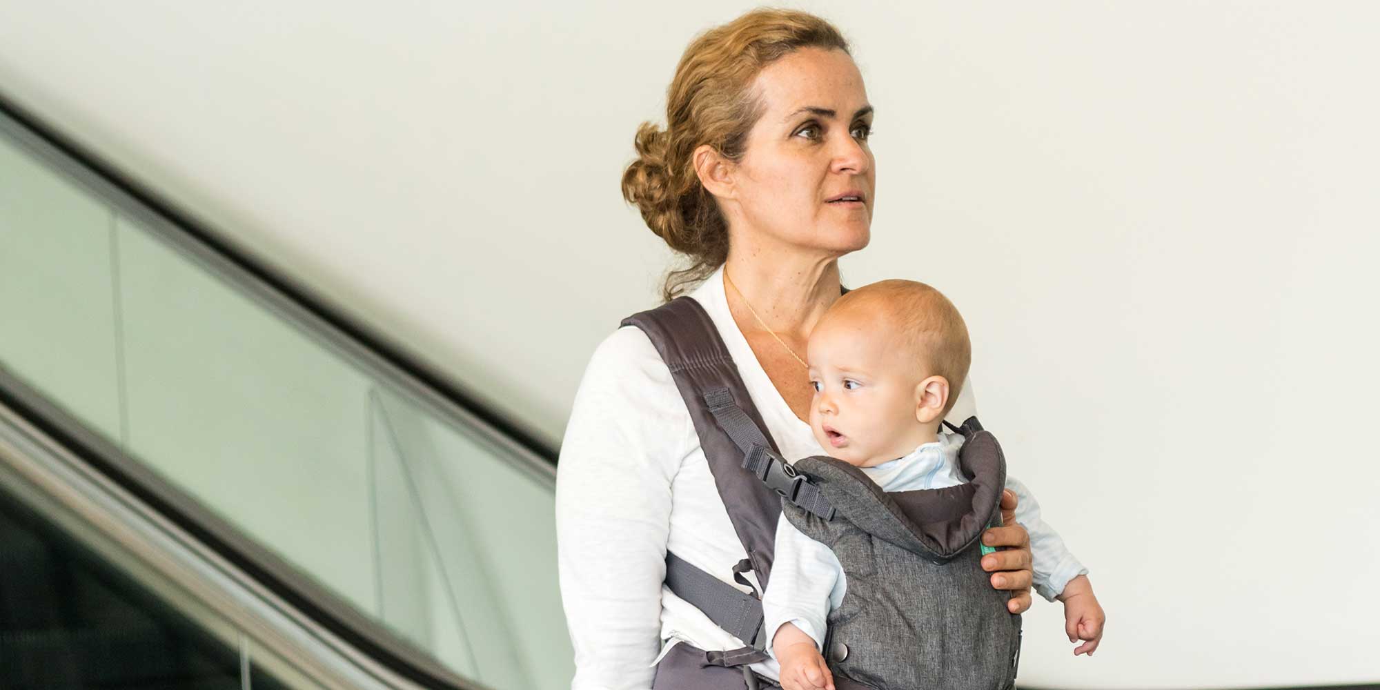 Woman carrying her baby on front in a baby carrier