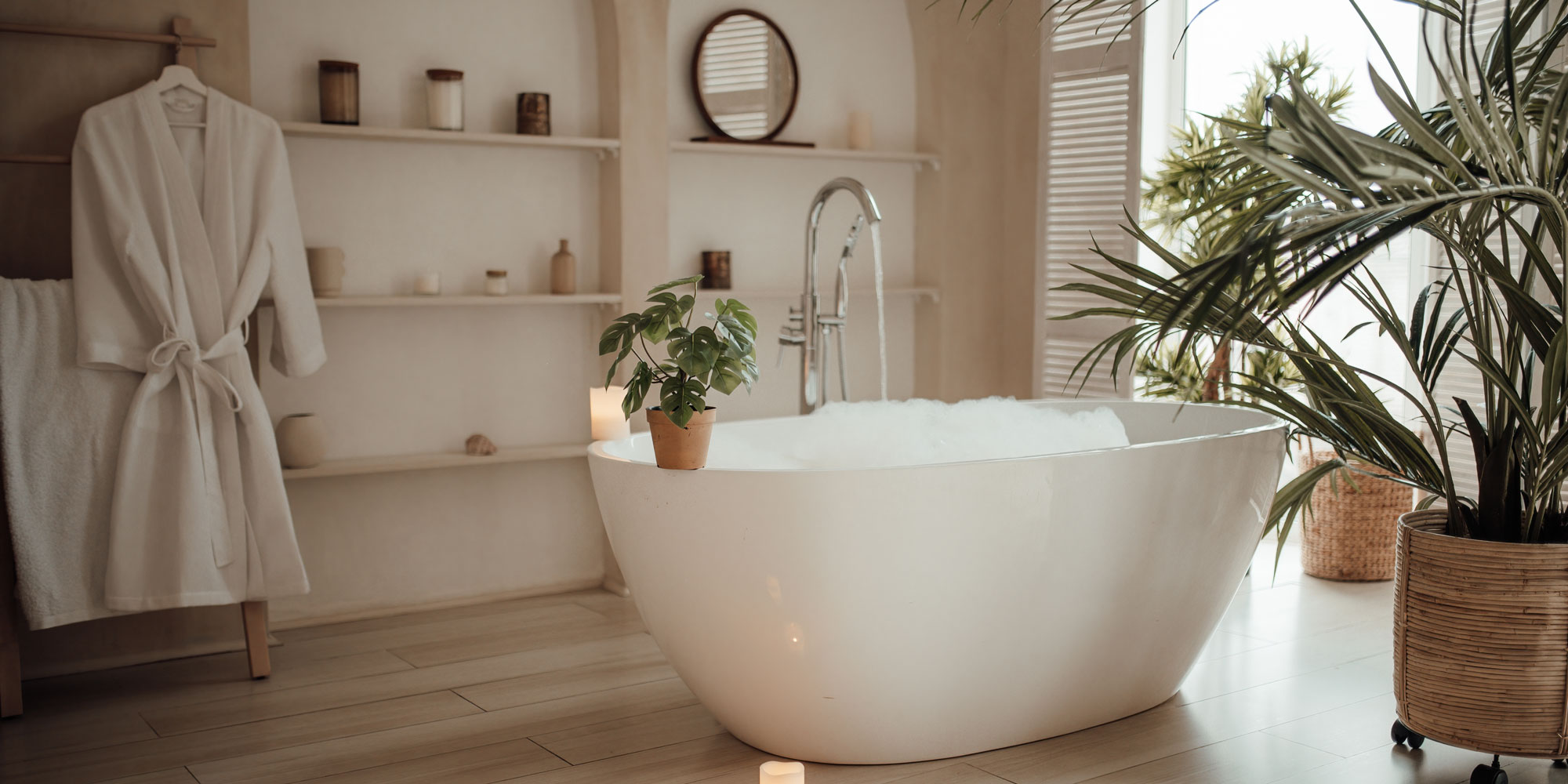 spa bathroom with freestanding bath and fluffy dressing gown