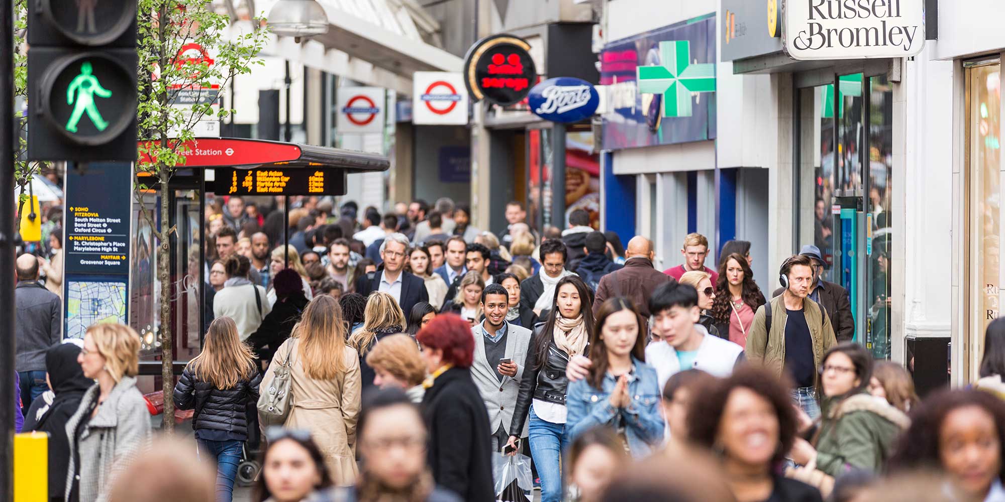 Busy city high street crammed with people