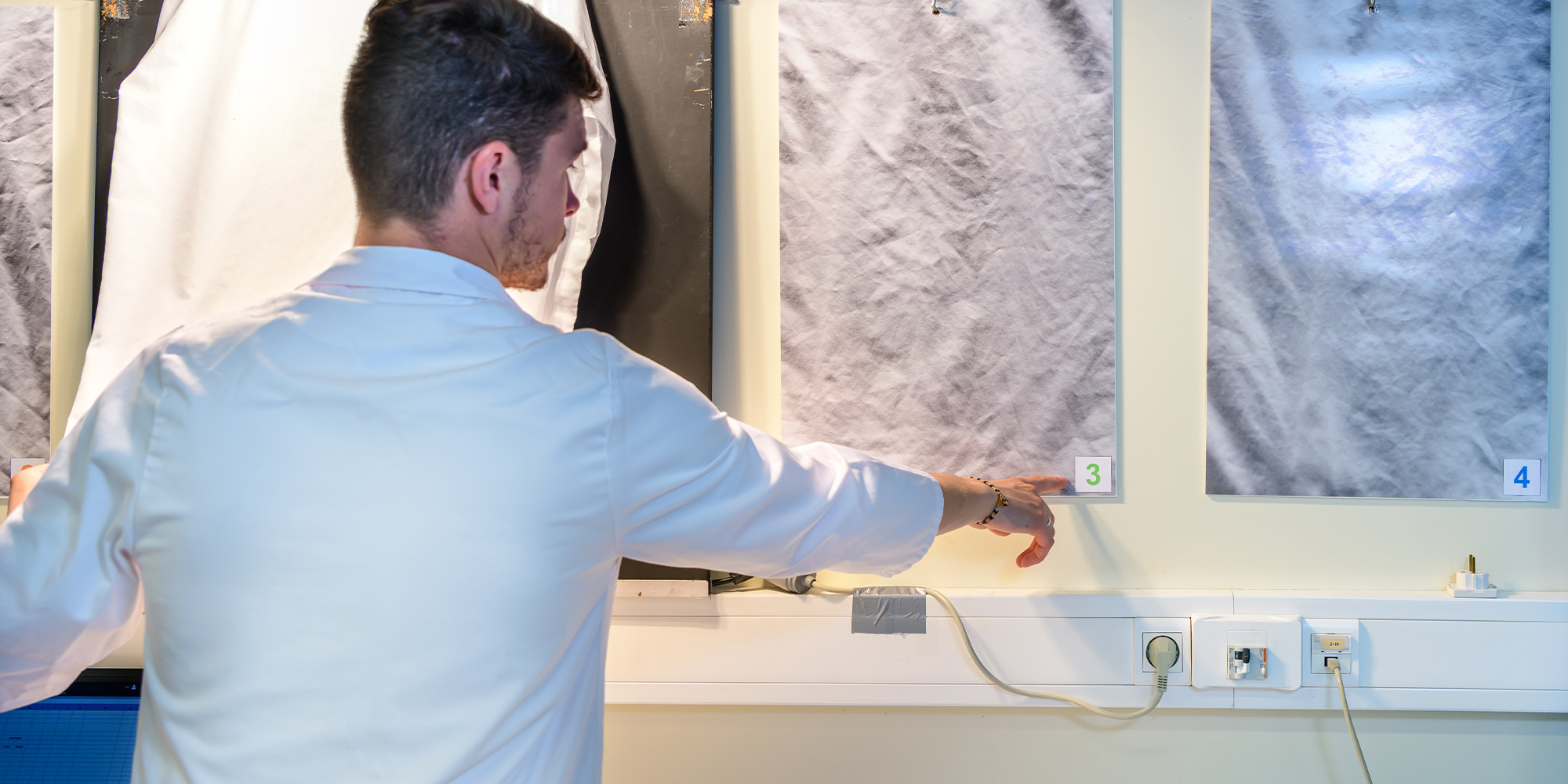 To assess how well a tumble dryer smooths out wrinkles, lab technicians study men's shirts after a synthetics cycle.
