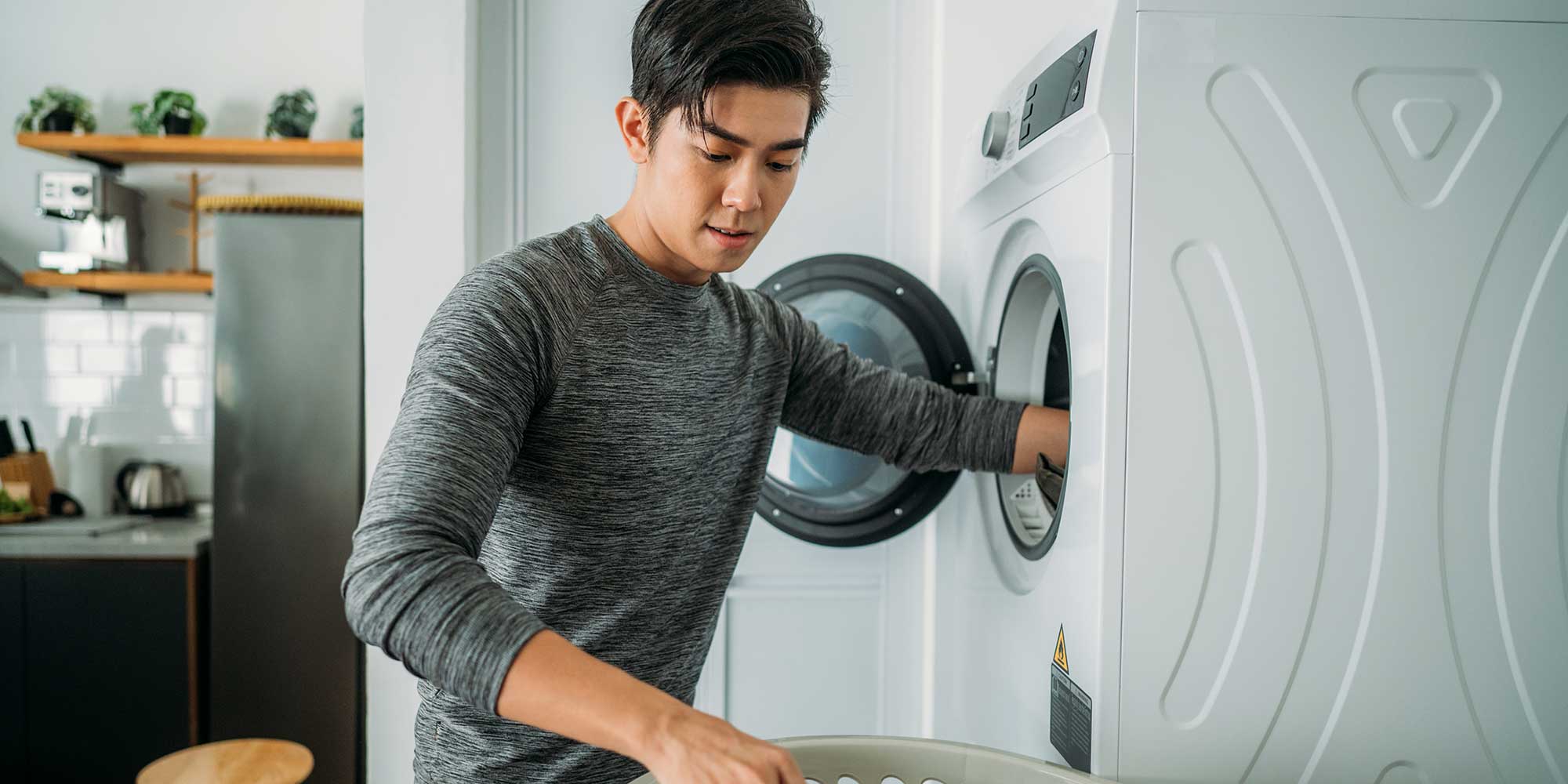 Man reaching inside washing machine