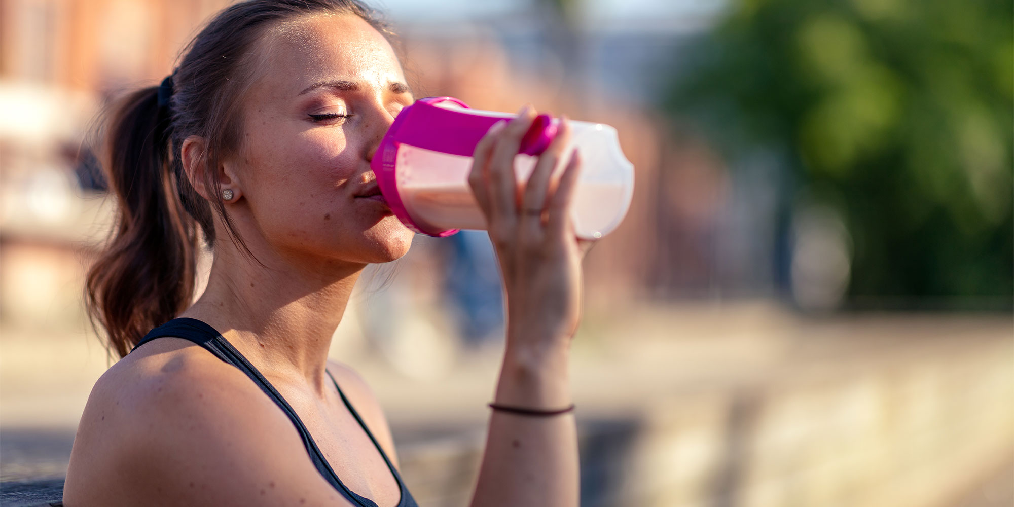 A woman drinking a protein shake