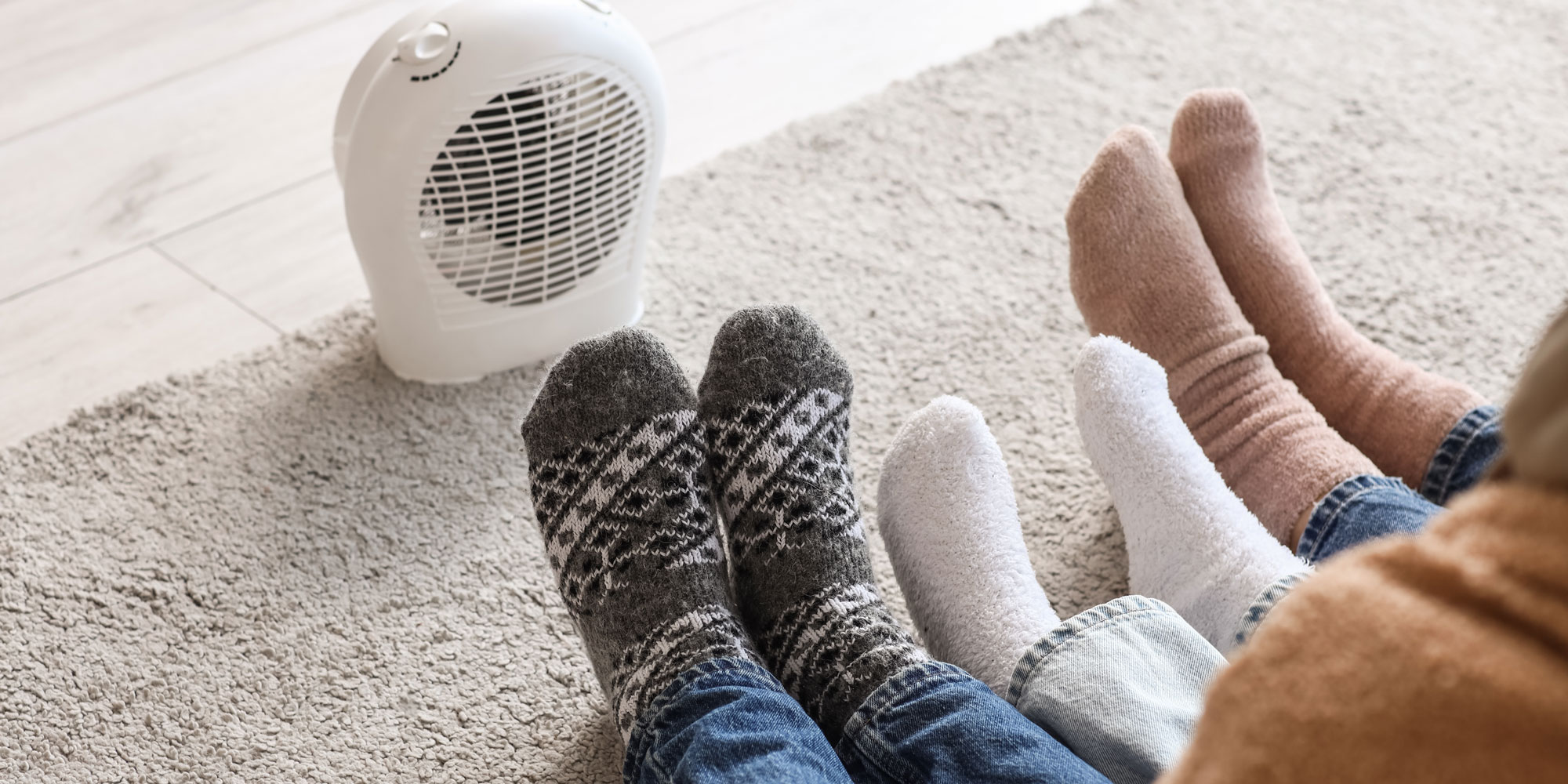 Socks and feet in front of an electric heater