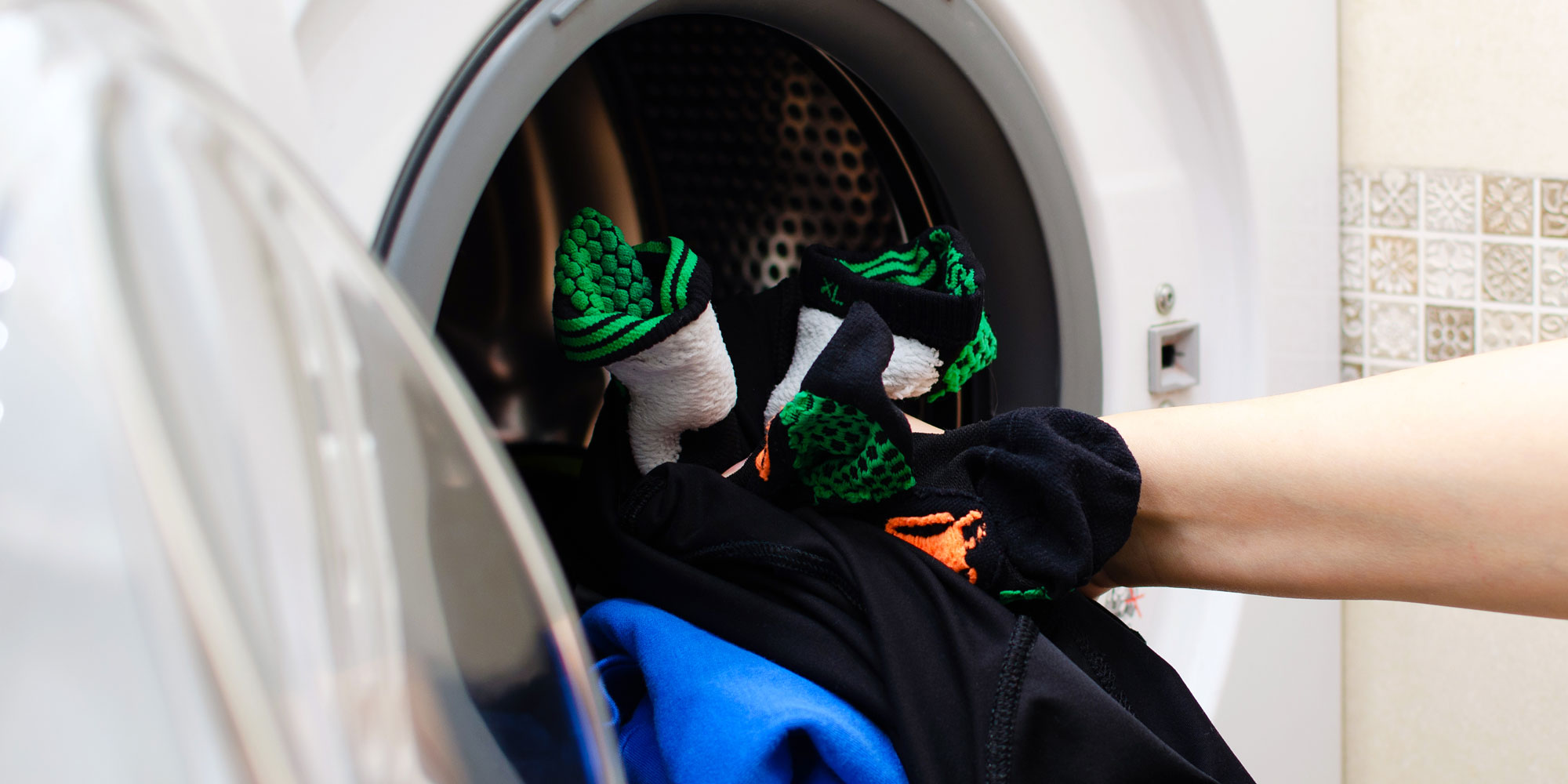 Loading sportswear into washing machine