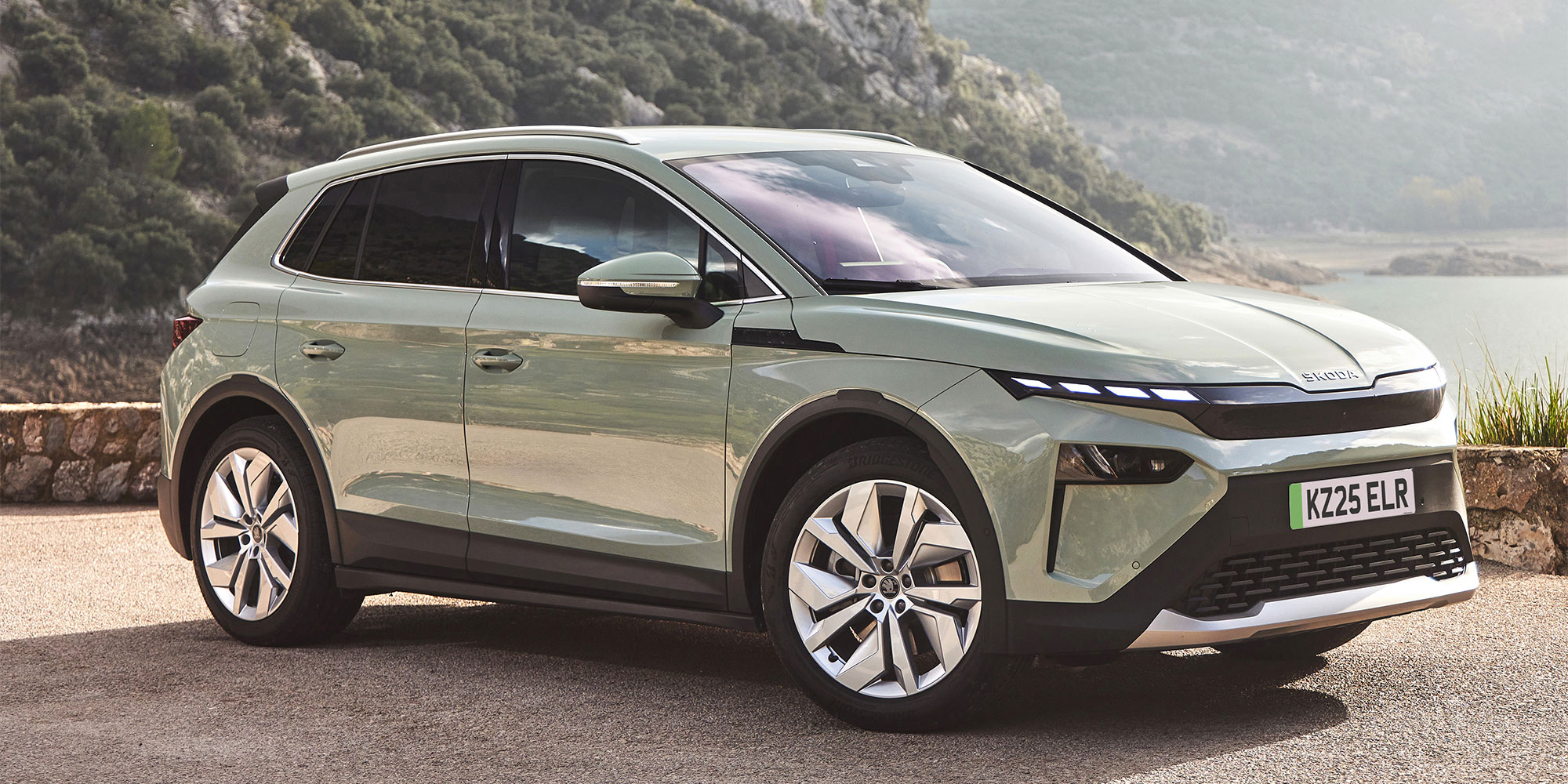 A grey Skoda Elroq, parked on a coastal road.