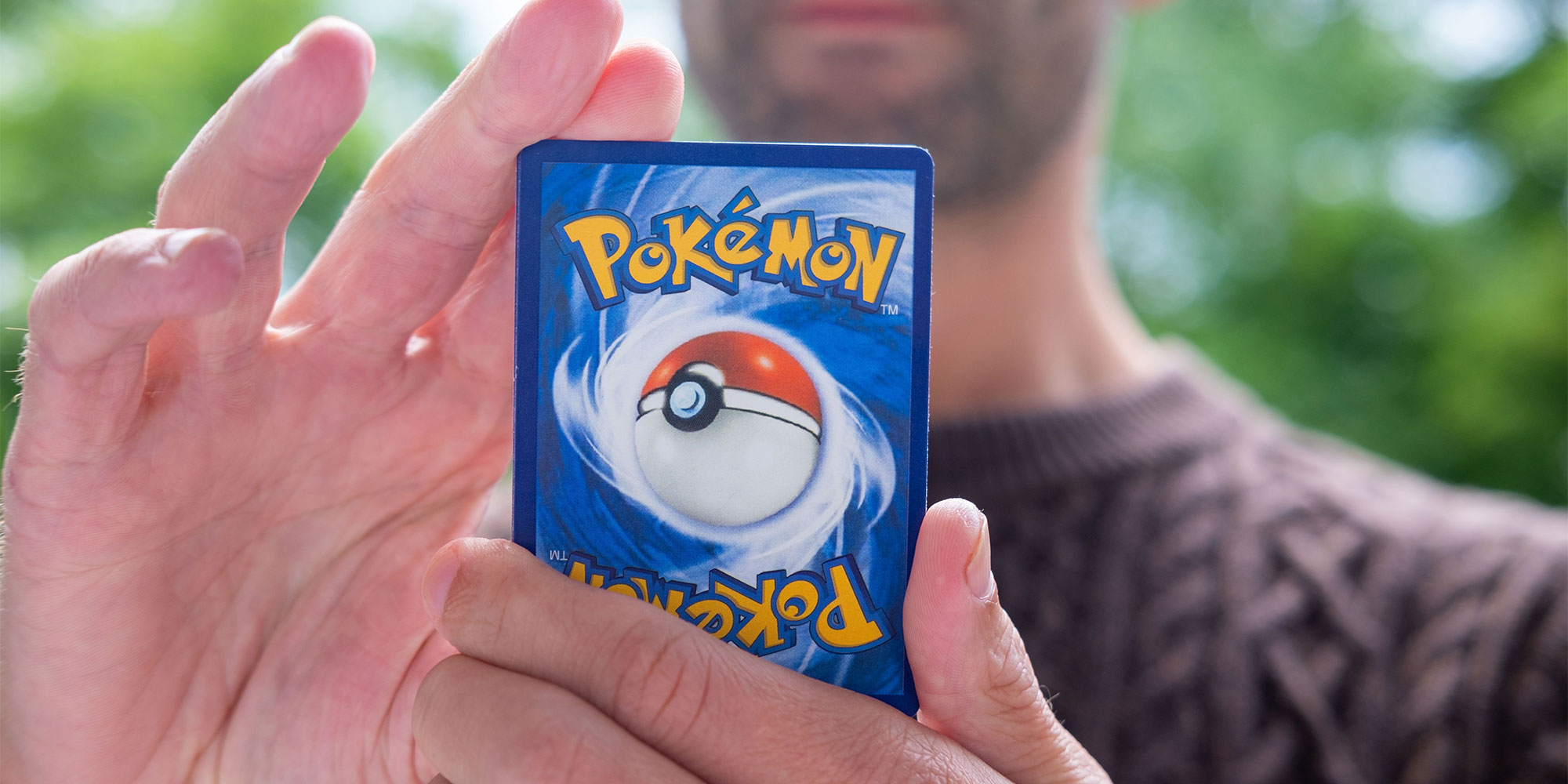 A man holding a pokemon card