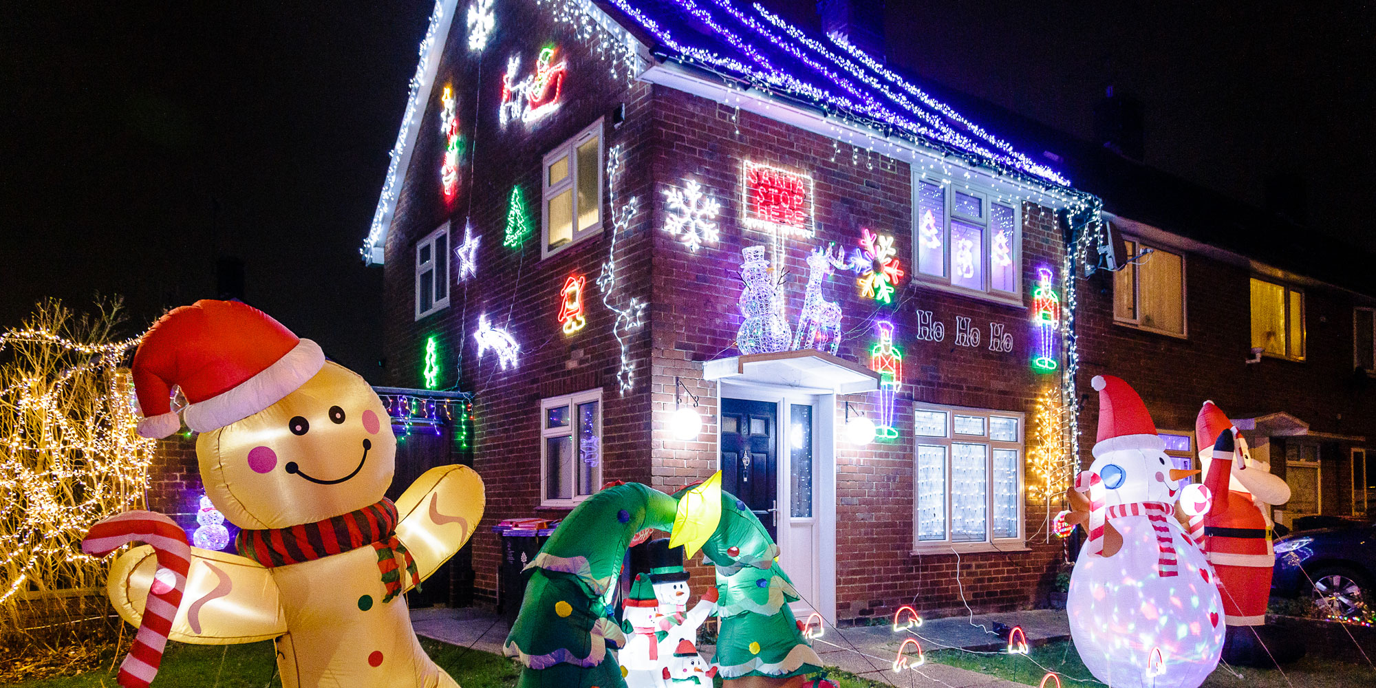 Exterior of house with lots of christmas lights