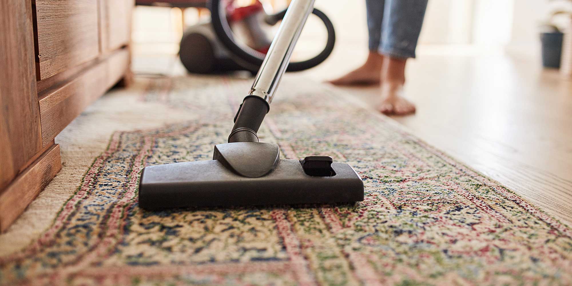 A patterned carpet being hoovered