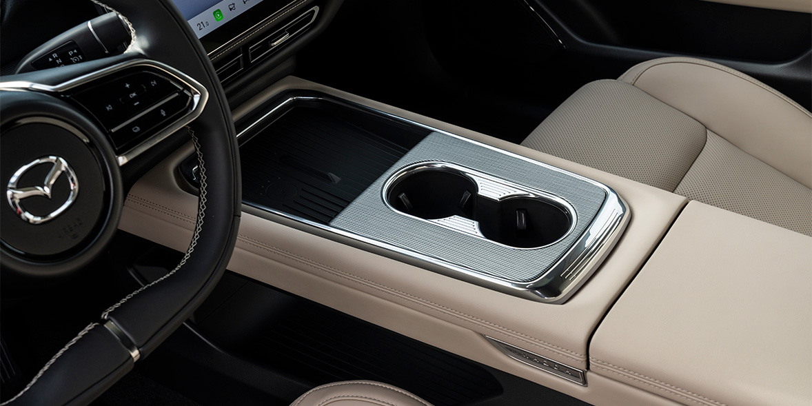 The centre console of the Mazda 6e, showing the armrest and cupholders
