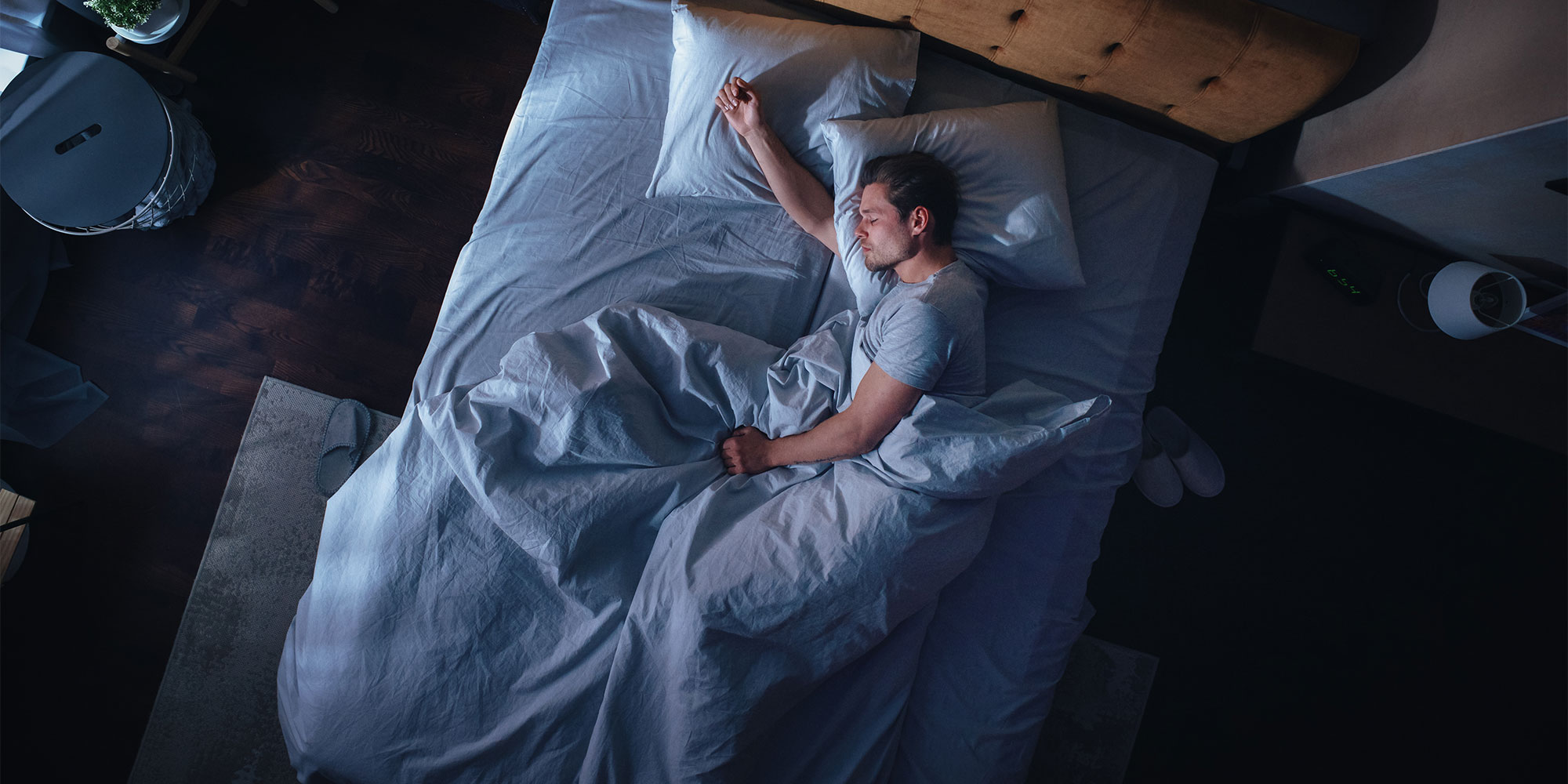A man lying in bed asleep on his side