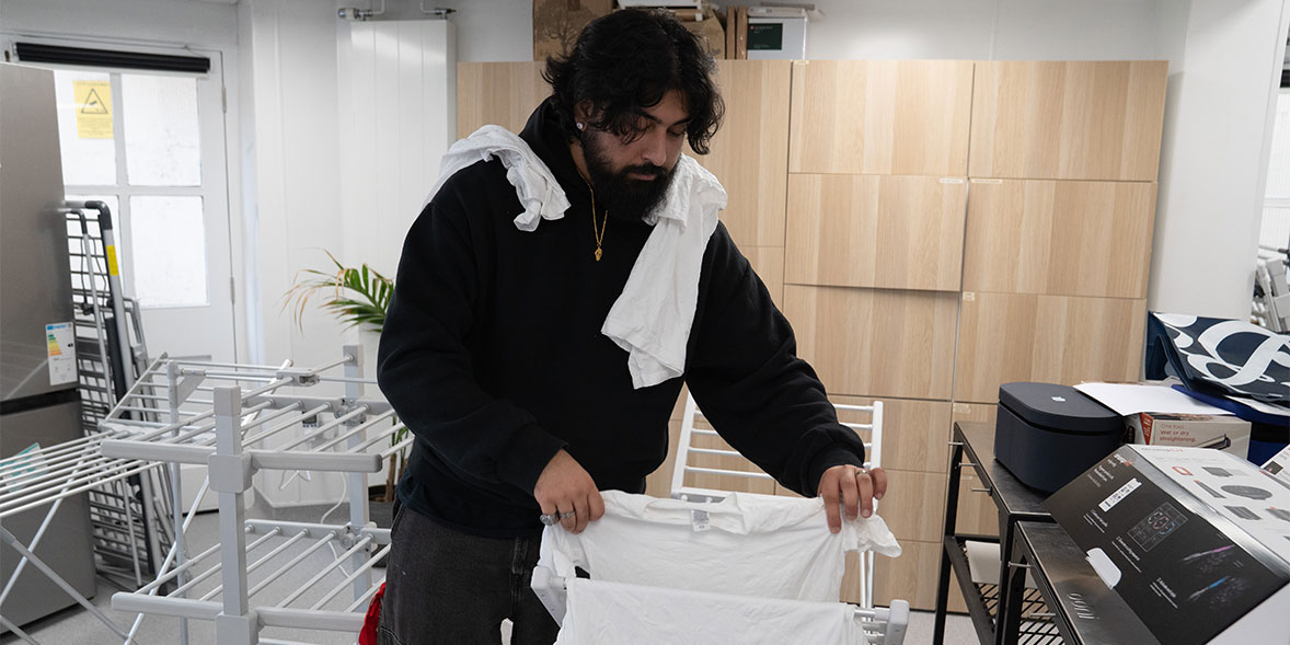 Our tester seeing how easy it is to fit clothes onto the bars