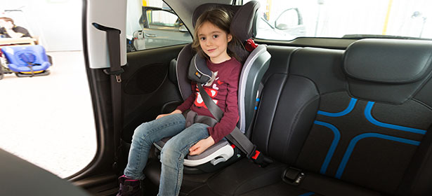 child in high back booster seat