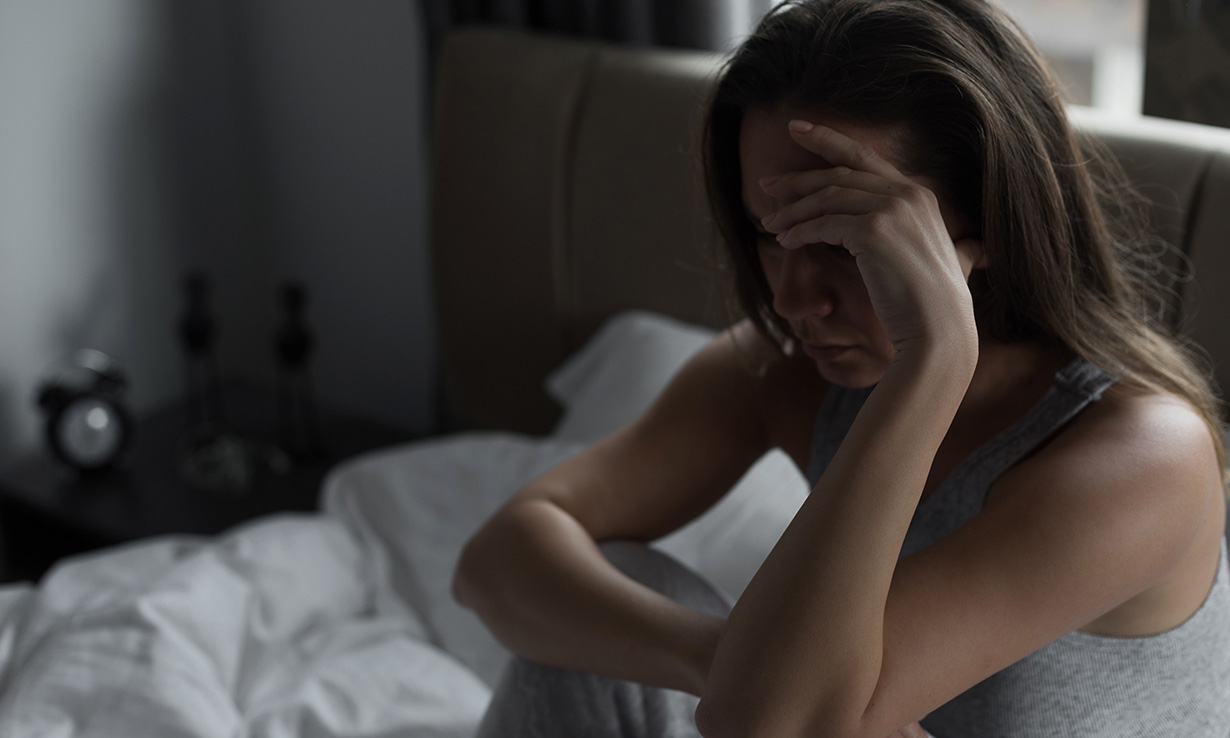 Woman struggling to sleep in hot weather