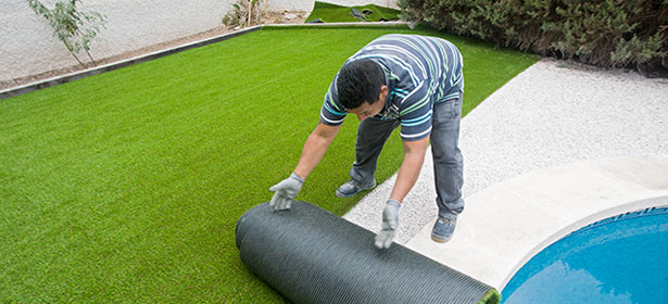 Laying artificial grass on prepared soil