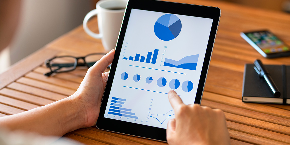 tablet with blue coloured pie, bar and line chart
