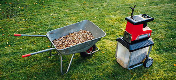 Garden shredder next to a wheelbarrow