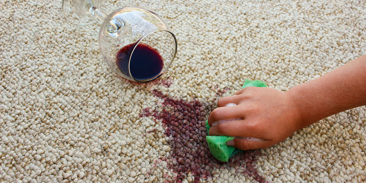 Glass of red wine spilt on carpet