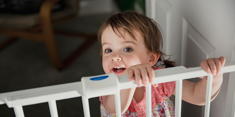 Child behind stair gate