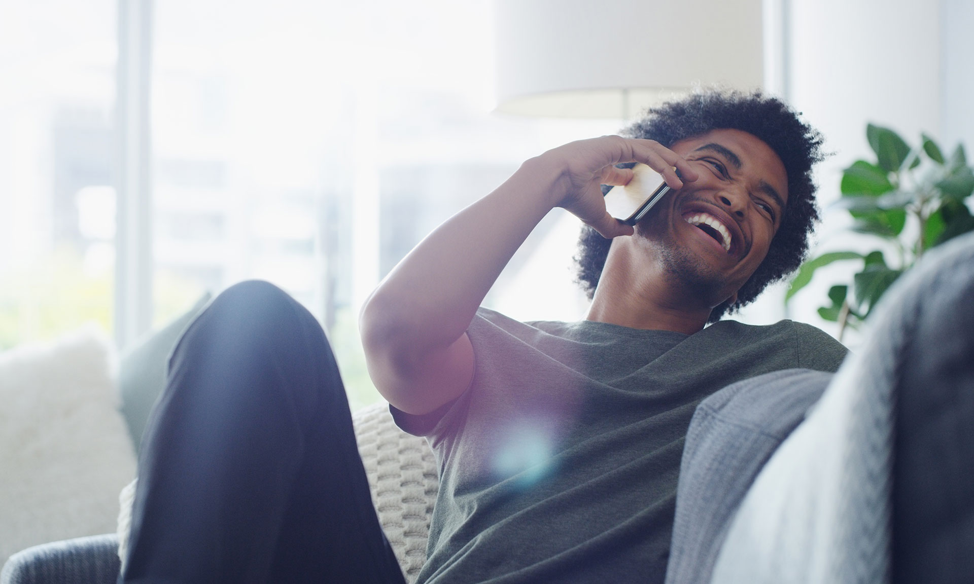 Man laughing while on the phone