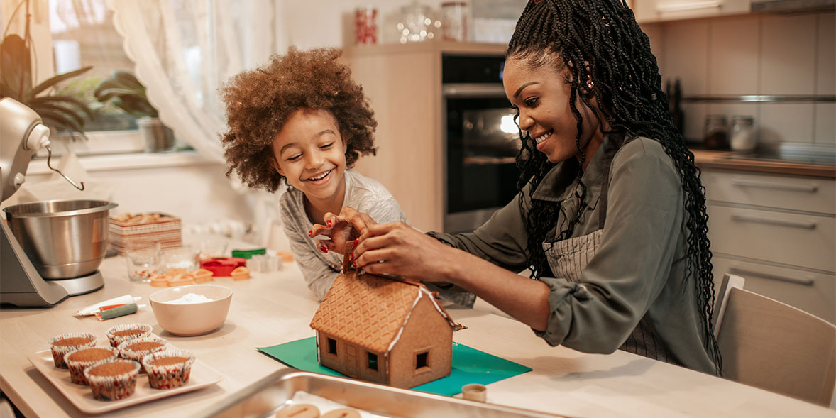 Family decorating a gingerbread house