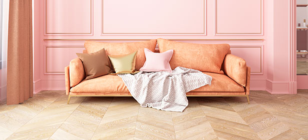 herringbone laminate flooring in a large room with pink walls