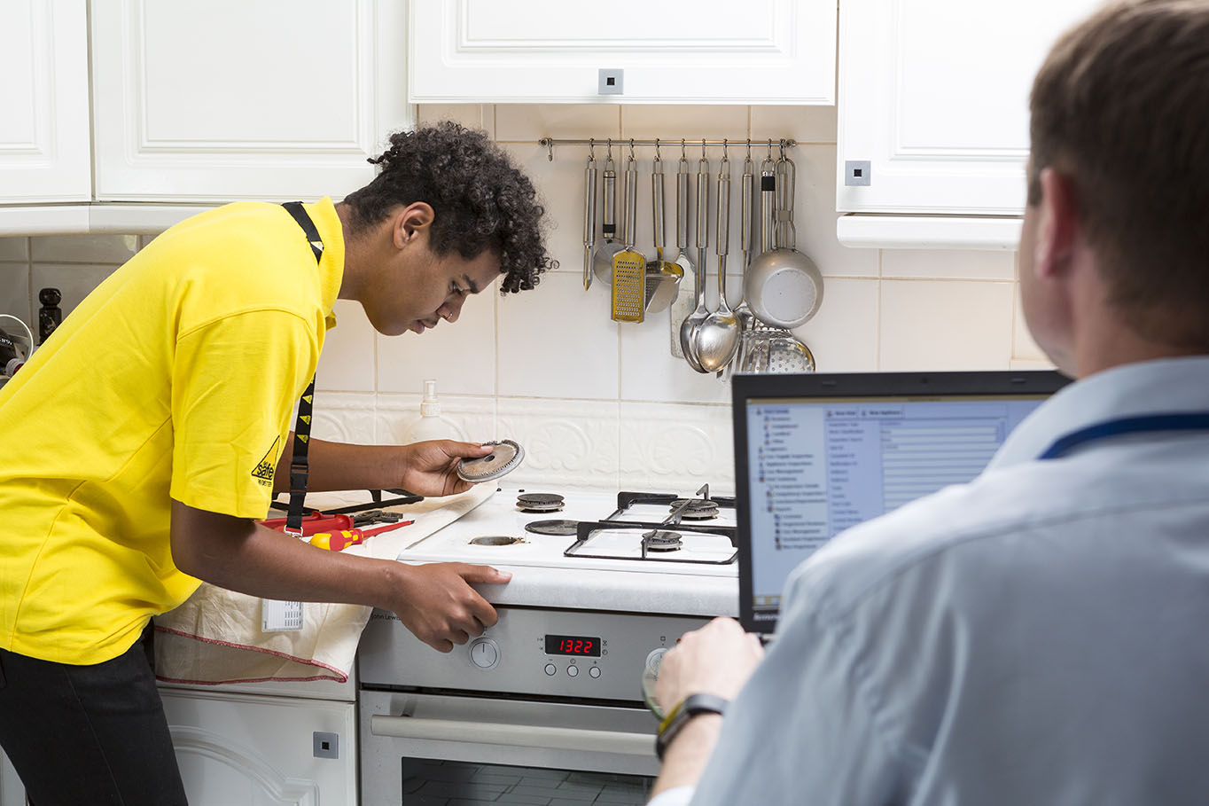 gas safety engineer checking gas hob